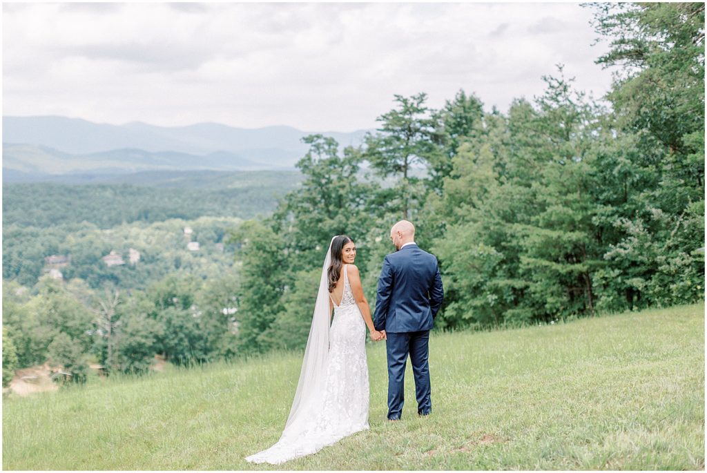 Virginia Wedding - bride and groom walking on mountain top 