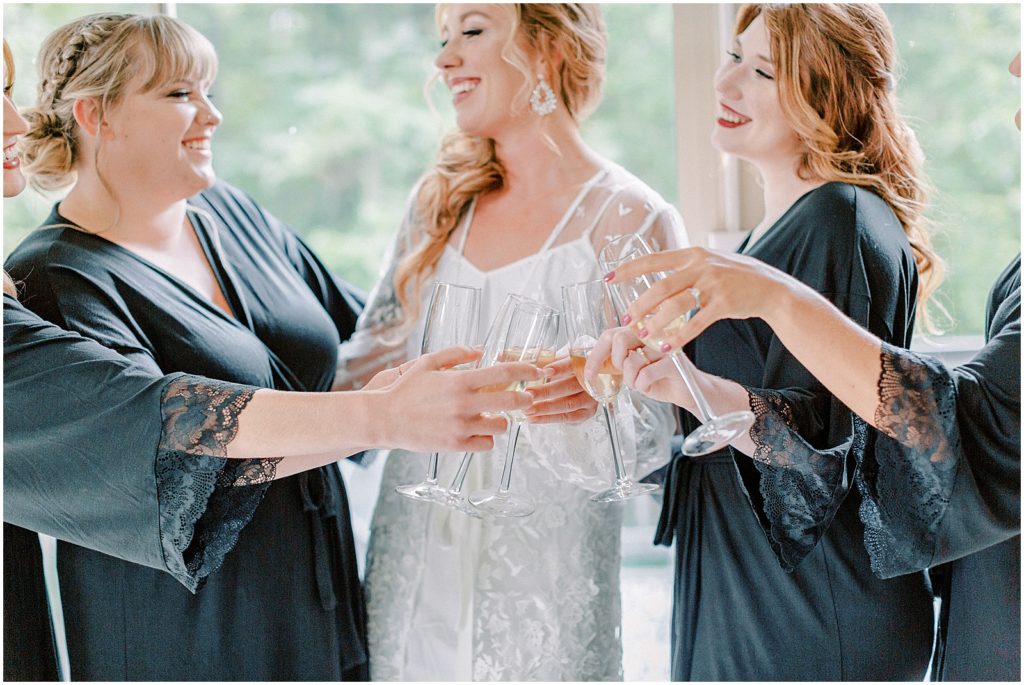 Bridesmaids and bride - cheers with champagne on wedding day