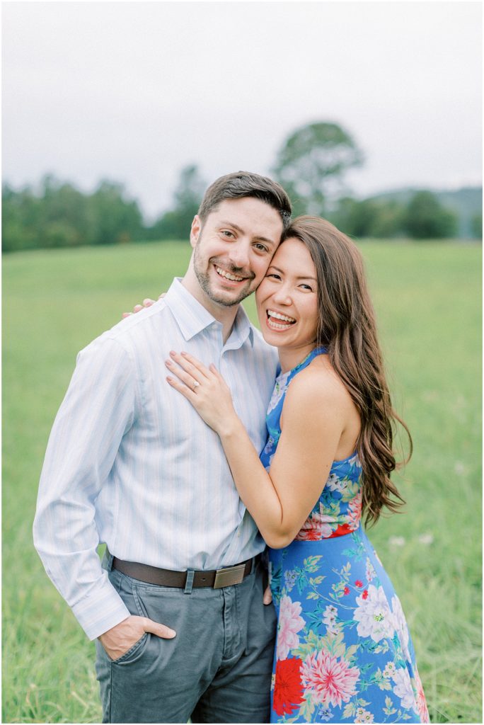 Couple looking at the camera and smiling at engagement session